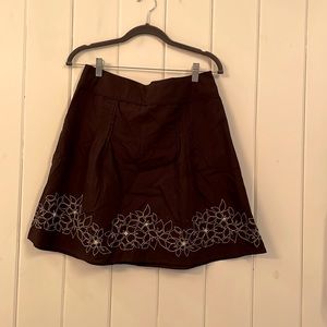 Knee length brown skirt with pretty white flower pattern.